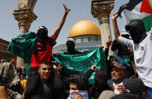 Palestinians demonstrate at Al-Aqsa Mosque as Palestinian Muslims attend Friday prayers of the Muslim holy month of Ramadan, on the compound known to Muslims as the Noble Sanctuary and to Jews as the Temple Mount, in Jerusalem's Old City, April 7, 2023. (credit: AMMAR AWAD/REUTERS)